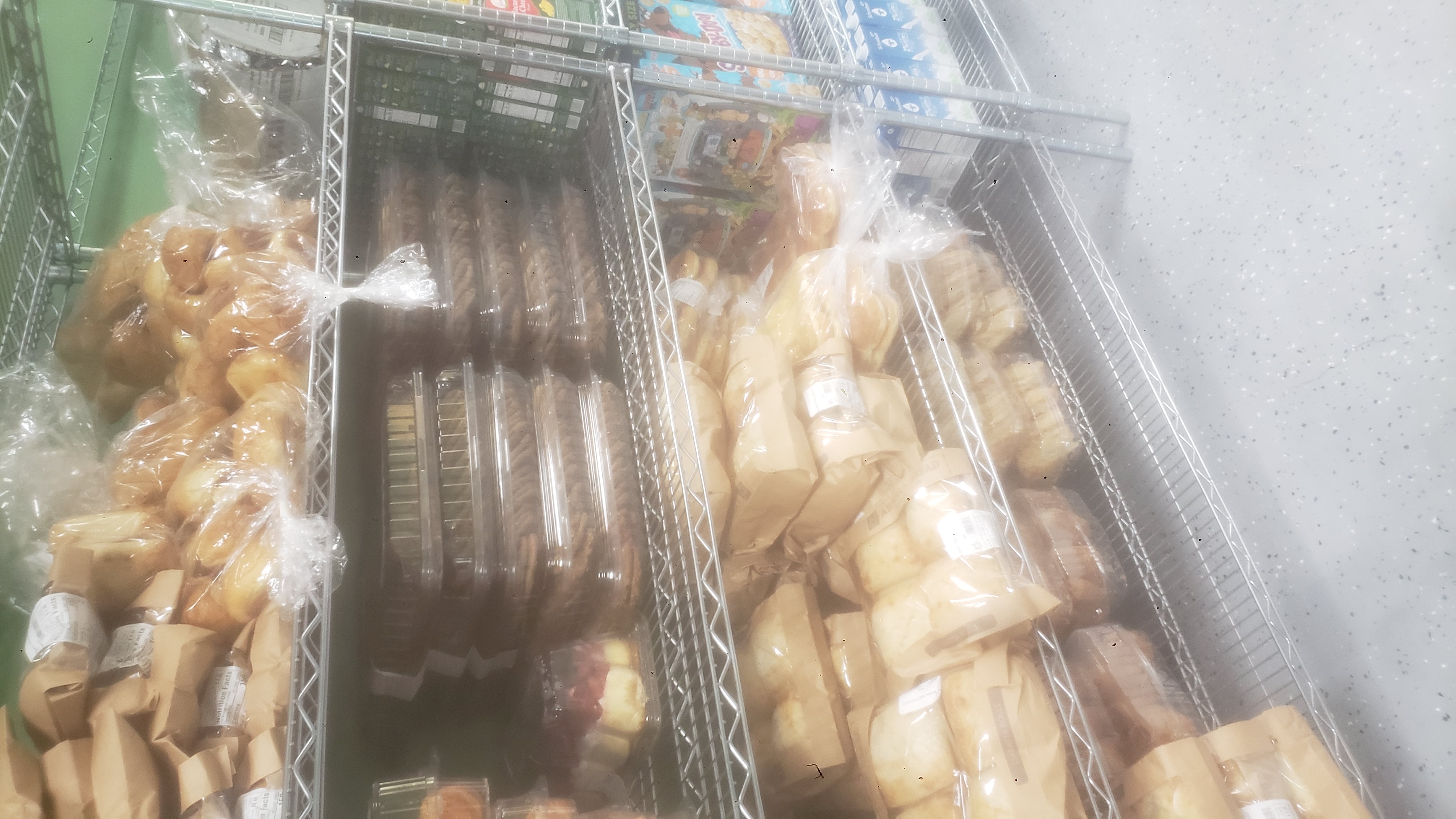 Assorted baked goods on racks of a shelf.
